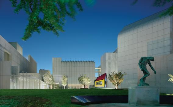 Nighttime scene of sculptures in the exterior High Museum plaza