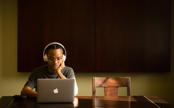 Student with headphones and laptop in the Matheson Reading Room
