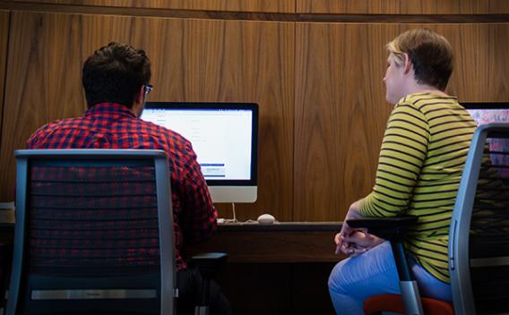 Student and Rose Library staff member looking at a desktop computer